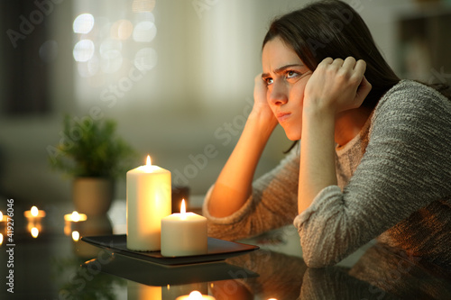 Angry homeowner using candles during power outage photo