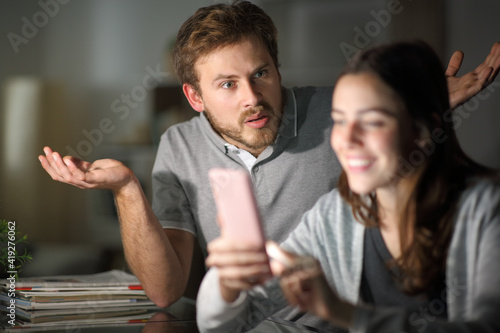 Tableau sur toile Wife using phone ignoring her husband in the night