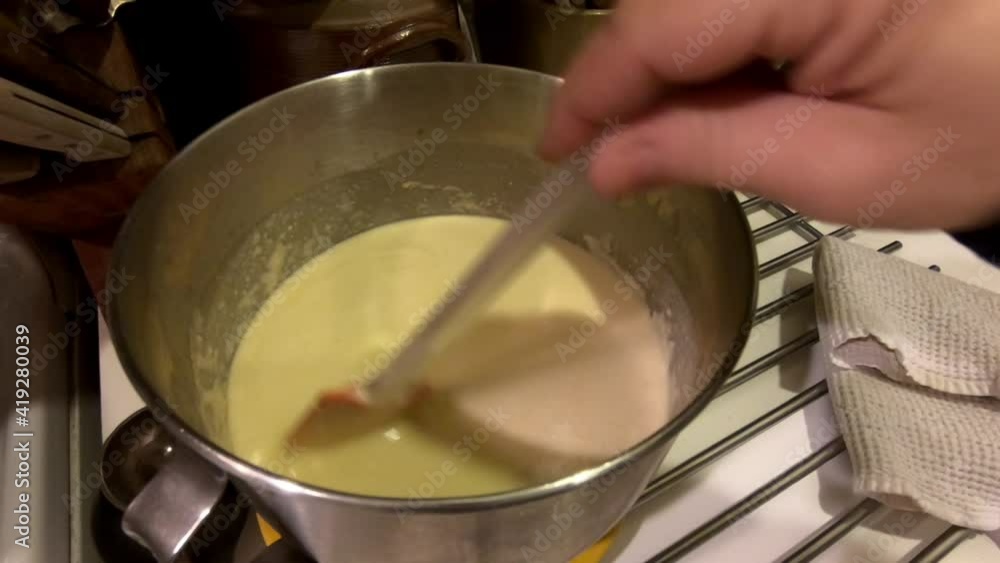 stirring the dough before cooking French crepes for Chandeleur stirring the dough before cooking French crepes for Chandeleur