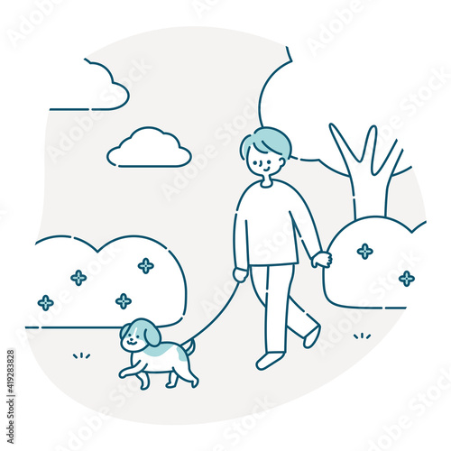 犬と公園を散歩する男性