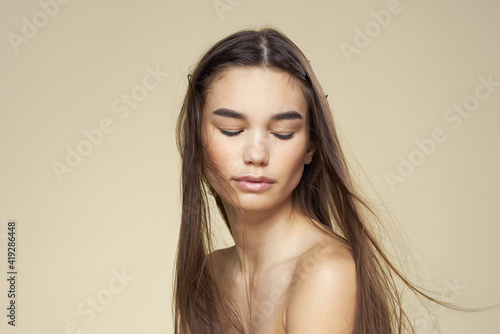 Wallpaper Mural Pretty woman naked shoulders long hair body care beige background Torontodigital.ca