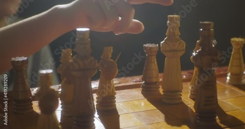 Game of chess. Checkmate the king, hand droping the king's piece, game over. photo