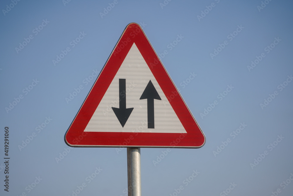 Traffic in both directions. Road sign. Traffic in both directions. Road sign.
