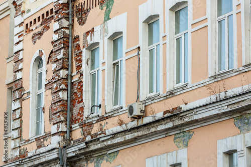 Close-up. The facade of the historic building is collapsing. Collapsing walls of an architectural monument.