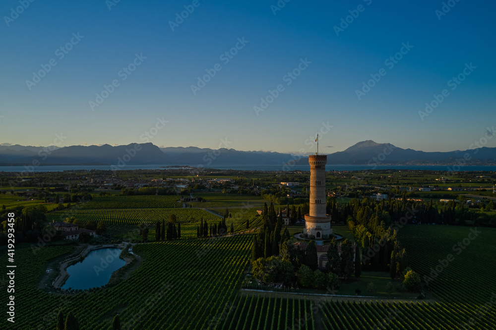 Tower of San Martino della Battaglia, Italy. Aerial view of Lake Garda. Photo with drone. Vineyards of Italy on Lake Garda Italy. Lake Garda view point Torre di San Martino. Sunset.