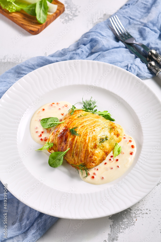 Zander Fish Baked in Dough with Caviar and Cream Sauce. Restaurant food plate on white table. Delicious baked fish meal. Zander Fish Baked in Dough with Caviar and Cream Sauce. Restaurant food plate on white table. Delicious baked fish meal.
