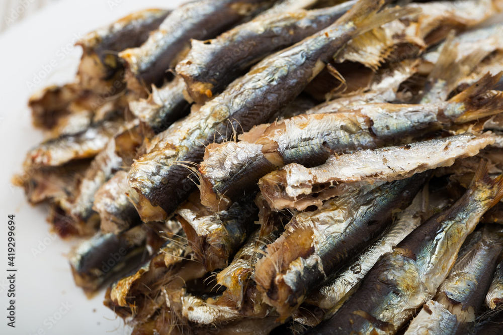 Fototapeta premium Healthy food. Delicious sardines baked in oven served on white plate..
