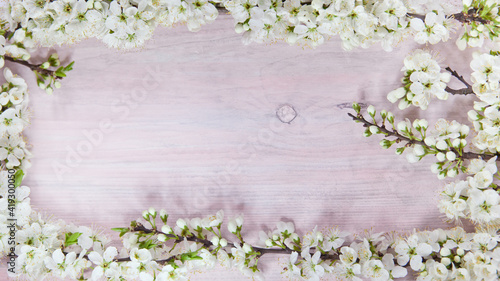 Spring flowering branch on wooden background. Copy space.