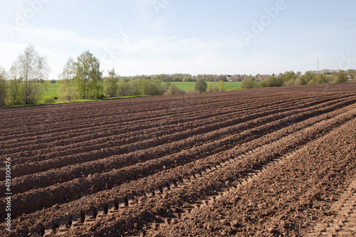 Furrows on a plowed field. Agricultural fields in Russia.