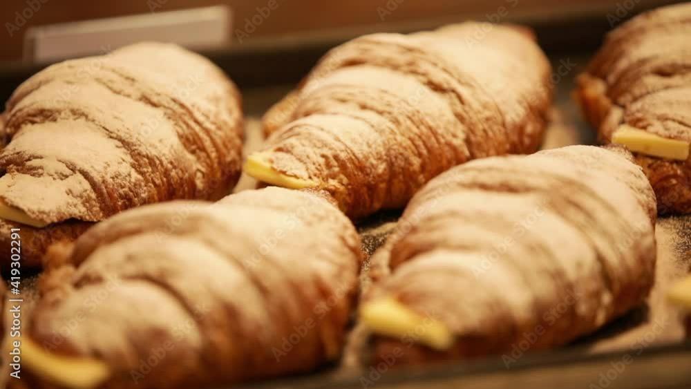 Croissant breads sandwich with butter inside at wooden trays Croissant breads sandwich with butter inside at wooden trays
