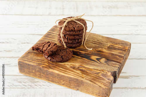 stuck of chocolate brownie cookies on wooden background. Homemade fresh pastry.