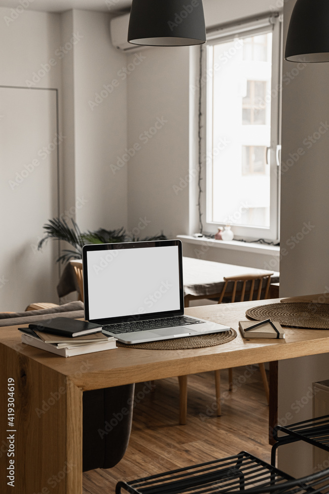 Blank screen laptop computer. Home office desk table workspace. Modern nordic interior design. Copy space mockup template. Front view work at home, pandemic quarantine self-isolation business concept. Blank screen laptop computer. Home office desk table workspace. Modern nordic interior design. Copy space mockup template. Front view work at home, pandemic quarantine self-isolation business concept.