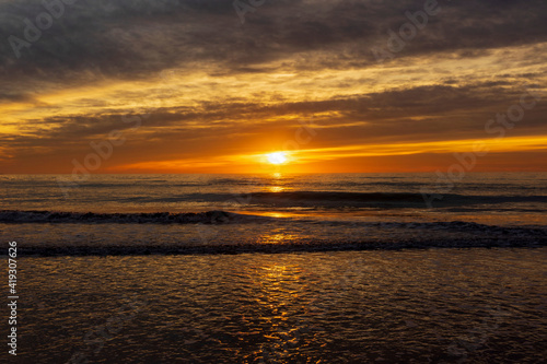 A beautiful sunrise from the shore of the beach © vicenfoto