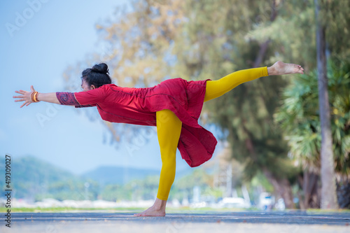 Sport woman wear India sport wear style posing practice yoga on beach ,yoga is healthy sport balance meditation body concept.