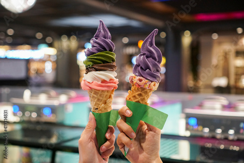 Rainbow soft serve ice cream tower. Two cone of rainbow ice cream with 5 flavour, strawberry, chocolate, milk, matcha green tea and purple sweet potato.