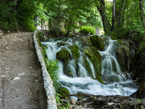 Waterfall with turquoise water in the Plitvice Lakes National Park, Croatia.