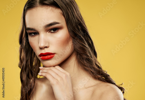 Pretty woman with naked shoulders red lips brunette