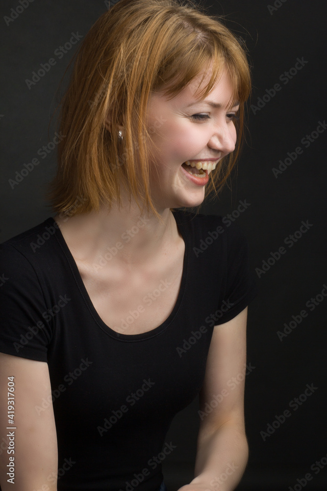 studio portrait of a young brown-haired woman, on a black background studio portrait of a young brown-haired woman, on a black background