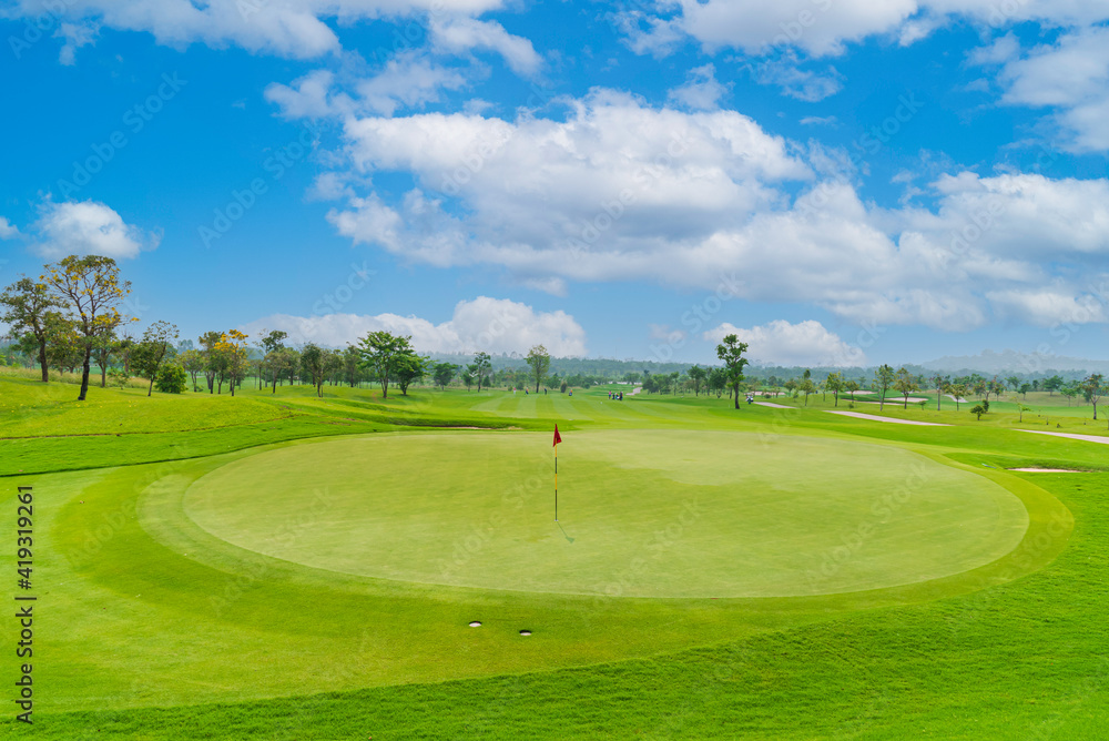 Beautiful view landscape in morning time green grass at golf course ,big trees, sand bunker and mist with sunlight rays background.