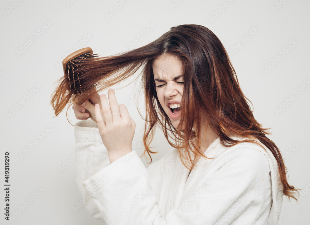 woman combing hair brittle ends split ends health problems woman combing hair brittle ends split ends health problems