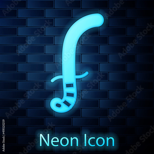 Glowing neon Medieval sword icon isolated on brick wall background. Medieval weapon. Vector.