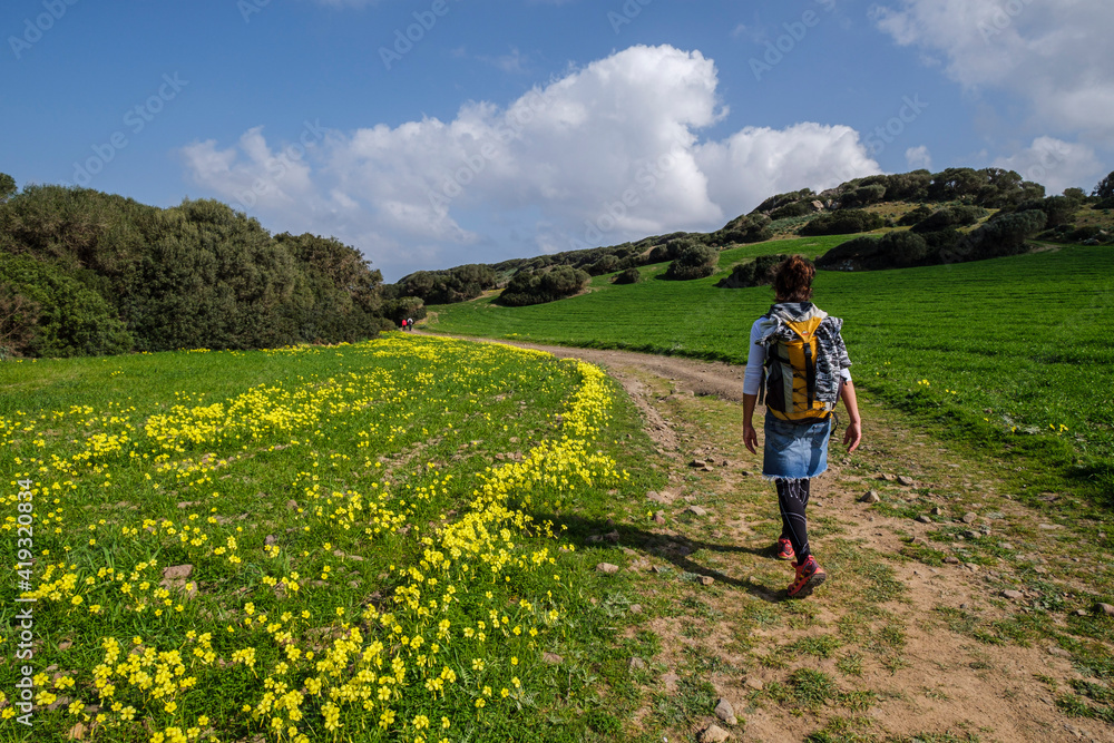 hiker walking the horse path, - Cami de Cavalls-,s'Albufera des Grau Natural Park, Menorca, Balearic Islands, Spain