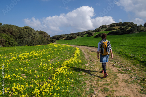 hiker walking the horse path  - Cami de Cavalls- s Albufera des Grau Natural Park  Menorca  Balearic Islands  Spain