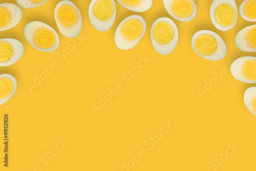 Banner with boiled half cut eggs pattern on yellow background. frame of boiled egg halves with space for text