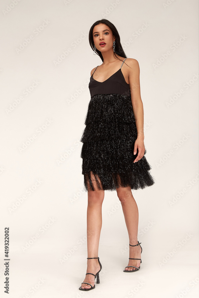 Sexy pretty woman tanned skin long brunette dark hair bright makeup wear fashion party style sequins little black dress for meeting date celebration evening high heels shoes glamour lifestyle luxury. Sexy pretty woman tanned skin long brunette dark hair bright makeup wear fashion party style sequins little black dress for meeting date celebration evening high heels shoes glamour lifestyle luxury.