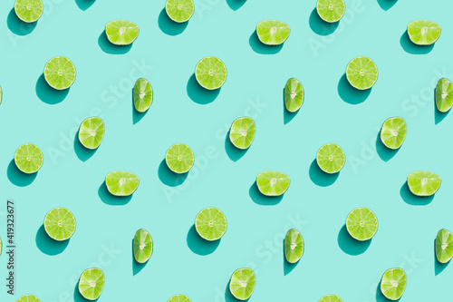 Summer fruits top view, bright juice citrus green lime on blue background. Healthy fruit food.