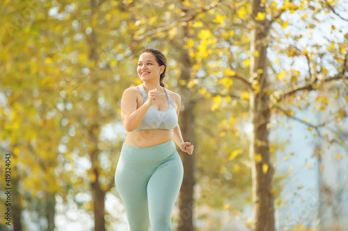 Fat woman jogging, doing sports for weight loss, obesity problem. High quality photo.