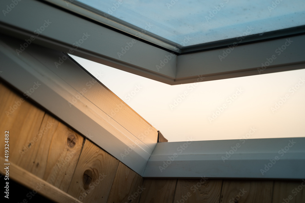 Obraz premium White wooden skylight, sunset light