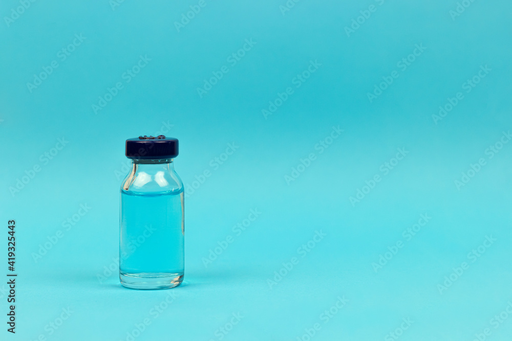 Medical concept - medical injection vial on blue background Medical concept - medical injection vial on blue background