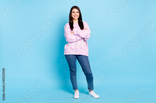 Full body photo of young woman happy positive smile confident crossed hands wear casual outfit isolated over blue color background