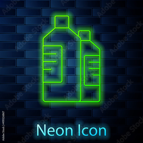 Glowing neon line Plastic bottles for laundry detergent, bleach, dishwashing liquid or another cleaning agent icon isolated on brick wall background. Vector Illustration.