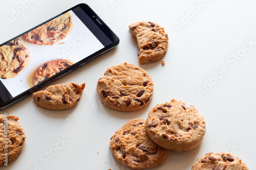 Fotobehang Pop-up cookies from smartphone concept