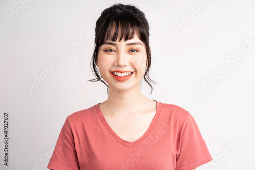 Young Asian woman posing on white background