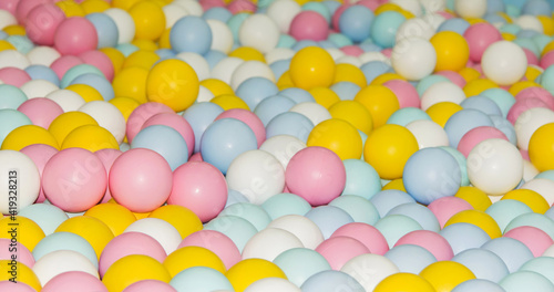 many small colorful plastic balls in the pool Children's playroom, pink, yellow, Blue, white