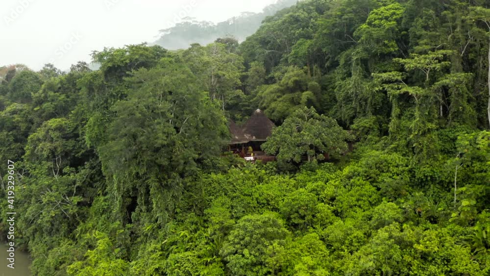 Aerial: Drone Moves High Into The Sky From Building In Deep Tropical Jungle Showing Dense Fog And Amazon River Aerial: Drone Moves High Into The Sky From Building In Deep Tropical Jungle Showing Dense Fog And Amazon River