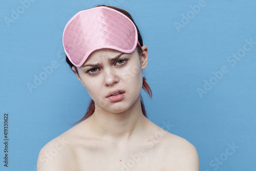 upset woman with sleep mask on her head gesturing with hands Copy Space