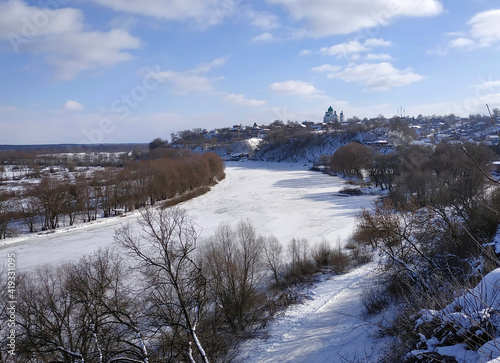 View from the high right bank to the turn of the Desna River and the city in the hills © goldika