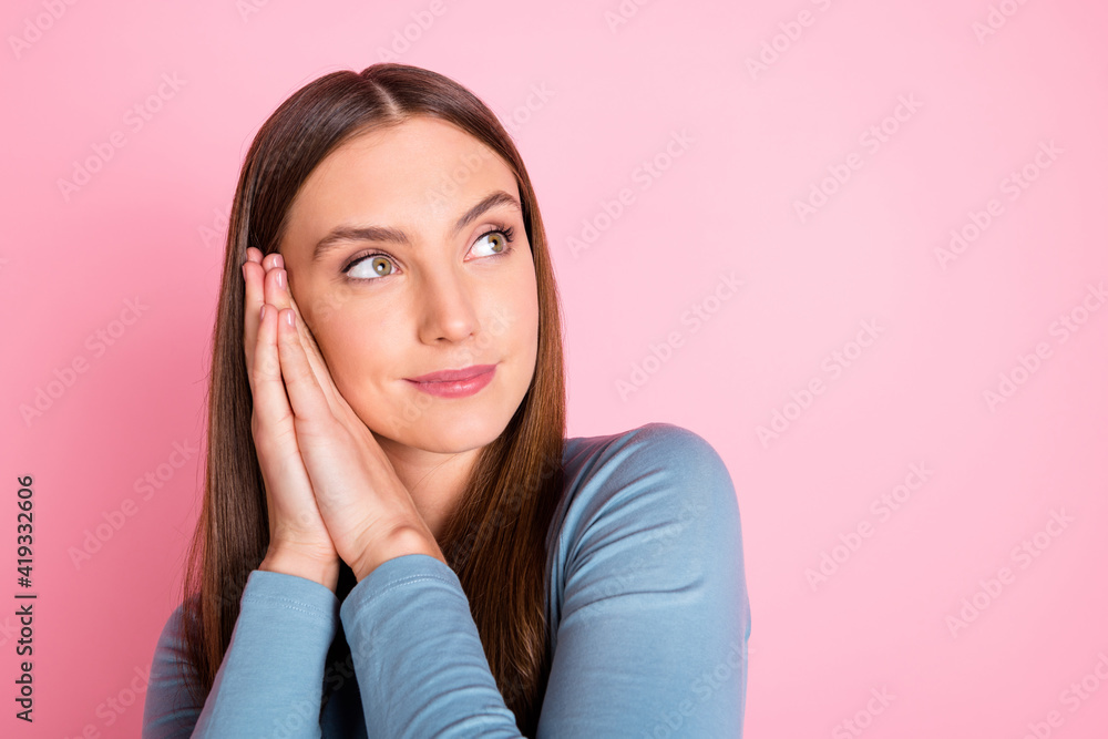 Photo of attractive positive girl hands palms under cheek look empty space isolated on pink color background Photo of attractive positive girl hands palms under cheek look empty space isolated on pink color background