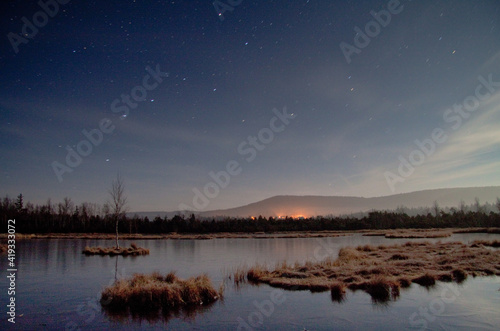 frozen lake on a starry night / Chalupska moor, Sumava national park, Czech Republic