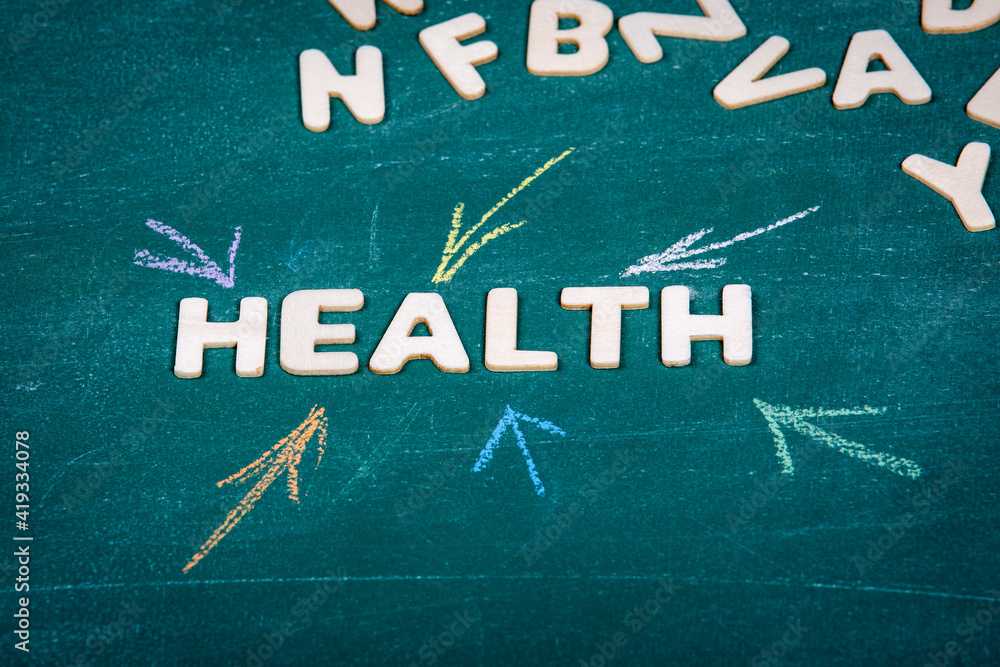 Fototapeta premium HEALTH. Care, treatment and diagnosis concept. White wooden alphabet letters
