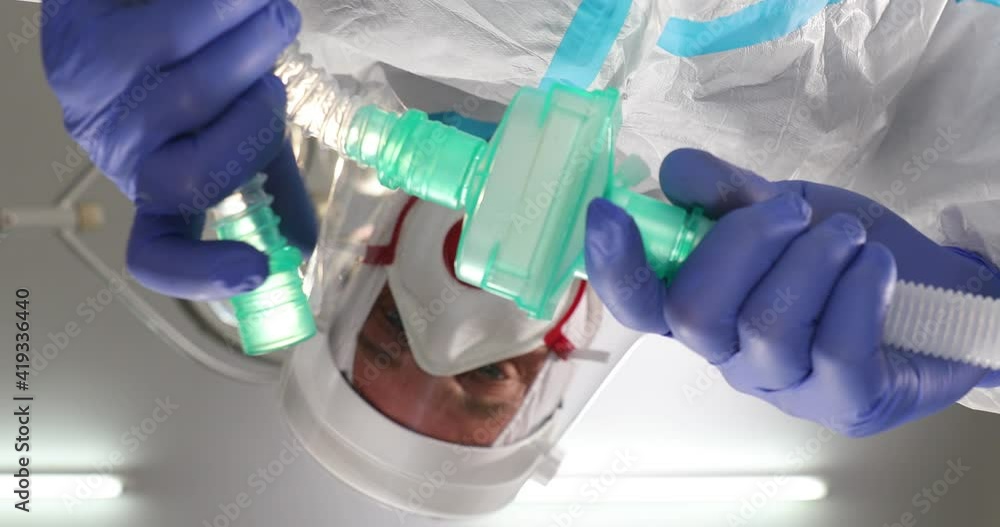 Anesthesiologist Doctor putting mask patient face, Low Angle Shot POV Patient View: Doctors and covid-19 patient with oxygen mask in bed in hospital, coronavirus concep. Anesthesiologist Doctor putting mask patient face, Low Angle Shot POV Patient View: Doctors and covid-19 patient with oxygen mask in bed in hospital, coronavirus concep.