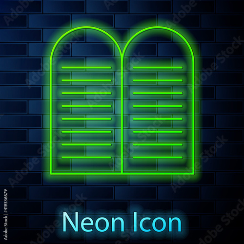 Glowing neon line The commandments icon isolated on brick wall background. Gods law concept. Vector.