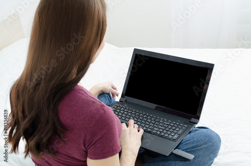 photo girl from the back. girl looking at laptop at home