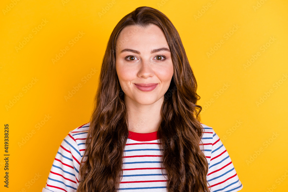 Photo of young happy positive good mood lovely beautiful girl with long wavy hair isolated on yellow color background Photo of young happy positive good mood lovely beautiful girl with long wavy hair isolated on yellow color background