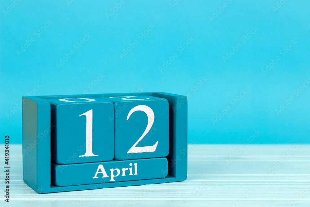 wooden calendar with date 12 april on blue wooden background, World Rock and Roll Day; World Aviation and Astronautics Day wooden calendar with date 12 april on blue wooden background, World Rock and Roll Day; World Aviation and Astronautics Day