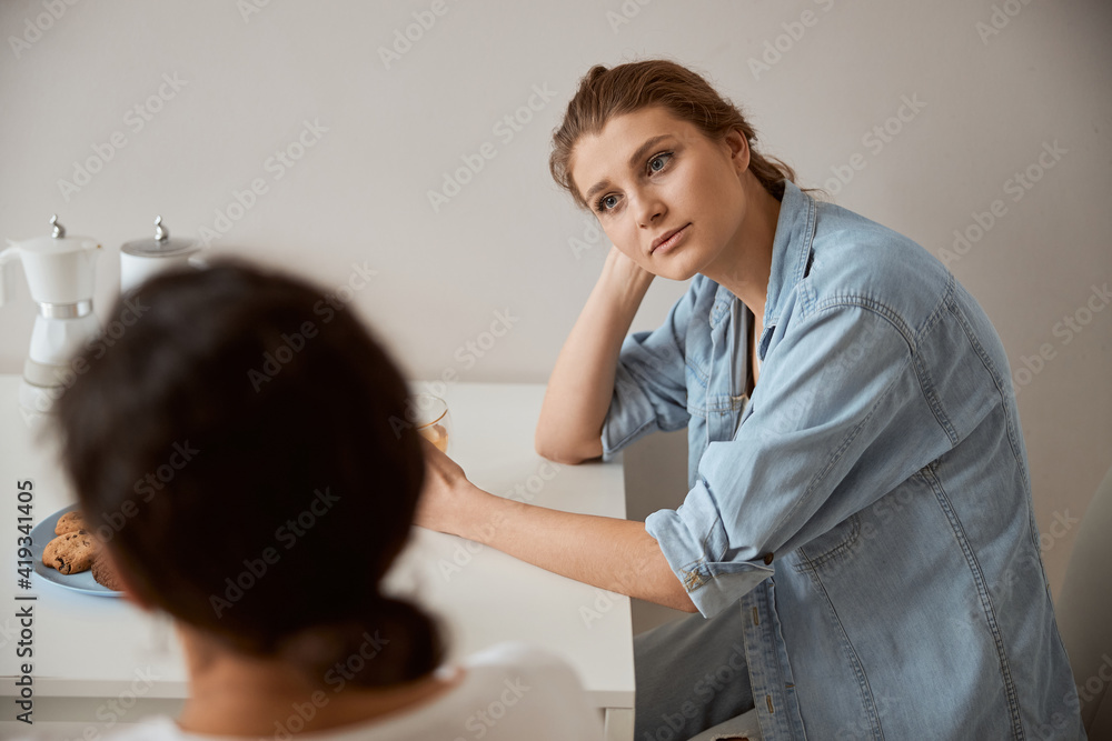 Fototapeta premium Cheerful female person being deep in her thoughts